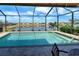 Sparkling screened pool overlooks a beautiful view of the adjacent waterway at 11842 Sistine Ln, Venice, FL 34293