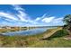 Picturesque view of the lake and surrounding properties from the back yard at 11842 Sistine Ln, Venice, FL 34293