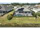 Aerial view of house with pool, screened enclosure, and lake access at 12353 Auburndale Ct, Venice, FL 34293