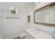 Clean bathroom with white vanity, a large mirror, and updated fixtures at 12353 Auburndale Ct, Venice, FL 34293
