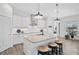 Modern kitchen with white cabinets, granite countertops, and island with seating at 12353 Auburndale Ct, Venice, FL 34293