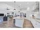 Modern kitchen with white cabinets, granite countertops, and island with seating at 12353 Auburndale Ct, Venice, FL 34293