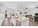 Updated kitchen with white cabinets, granite island, and stainless steel appliances at 12353 Auburndale Ct, Venice, FL 34293