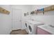 Laundry room with washer, dryer, and built-in shelving at 12353 Auburndale Ct, Venice, FL 34293