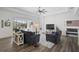 Open living area with hardwood floors, sectional sofa, and shiplap accent wall at 12353 Auburndale Ct, Venice, FL 34293