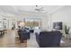 Spacious living area with hardwood floors, sectional sofa, and access to the patio at 12353 Auburndale Ct, Venice, FL 34293