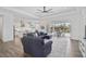 Open living space with hardwood floors, sectional sofa, and views of the pool at 12353 Auburndale Ct, Venice, FL 34293