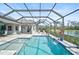 Resort-style pool and patio with screened enclosure and water feature at 12353 Auburndale Ct, Venice, FL 34293