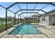 Enjoy this screened pool and spa with a tranquil lake view at 12353 Auburndale Ct, Venice, FL 34293