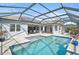 Relaxing pool and patio area with screened enclosure and solar panels at 12353 Auburndale Ct, Venice, FL 34293