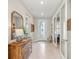 Bright and airy entryway with a stylish console table and mirror at 13315 Rinella St, Venice, FL 34293