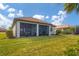 Large backyard with a view of the screened patio at 13334 Pacchio St, Venice, FL 34293