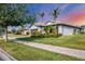 Single-story home with landscaping, driveway, and sidewalk at 13334 Pacchio St, Venice, FL 34293