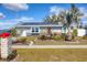 Charming single-story home with solar panels and landscaped front yard at 13492 Dibella Ave, Port Charlotte, FL 33981