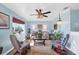 Living room with light blue walls, hardwood floors, and comfy seating at 13492 Dibella Ave, Port Charlotte, FL 33981