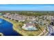 Community overview with pool and lake at 13542 Abercrombie Dr, Englewood, FL 34223