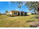 Backyard with lawn and screened enclosure at 13542 Abercrombie Dr, Englewood, FL 34223