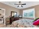 Main bedroom with king bed, dresser and access to en-suite bathroom at 13542 Abercrombie Dr, Englewood, FL 34223