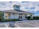Community clubhouse with a covered patio and parking lot at 13542 Abercrombie Dr, Englewood, FL 34223