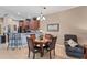 Bright dining area with a round wooden table and four chairs, adjacent to the kitchen at 13542 Abercrombie Dr, Englewood, FL 34223
