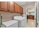 Laundry room with washer, dryer, and cabinets at 13542 Abercrombie Dr, Englewood, FL 34223