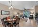 Open living space with tile floors, a comfy sofa, and access to a patio at 13542 Abercrombie Dr, Englewood, FL 34223