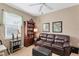 Home office with a leather couch, built-in bookcase, and window seating at 13542 Abercrombie Dr, Englewood, FL 34223