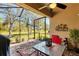 Screened patio with table and chairs at 13542 Abercrombie Dr, Englewood, FL 34223