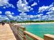 Wooden pier extending over a beautiful beach with turquoise water at 13678 Yelma St, Venice, FL 34293