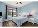 Bedroom with light blue walls and a large window at 13678 Yelma St, Venice, FL 34293