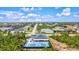 Beautiful home with a private backyard featuring a pickleball court, a pool, an outdoor entertainment space, and lush greenery at 14098 Baracoa Ln, Port Charlotte, FL 33981