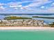 Beautiful aerial view of beachfront property, showcasing the sandy shore and serene turquoise waters at 14098 Baracoa Ln, Port Charlotte, FL 33981