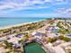 Gorgeous aerial view of a coastal city featuring beautiful sandy beaches and beachfront businesses and turquoise-blue water at 14098 Baracoa Ln, Port Charlotte, FL 33981