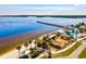Aerial shot capturing the outdoor amenities including pool, beach, pier, and recreational areas by the bay at 14098 Baracoa Ln, Port Charlotte, FL 33981