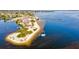Scenic aerial view of a beach with a sailboat, pier, and a beautiful shoreline at 14098 Baracoa Ln, Port Charlotte, FL 33981