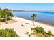 Scenic beach view with palm trees, white sand, and clear blue water inviting relaxation at 14098 Baracoa Ln, Port Charlotte, FL 33981
