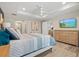 Spacious bedroom with a large bed, dresser, and TV at 14098 Baracoa Ln, Port Charlotte, FL 33981