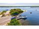 Aerial view of a boat dock with several boats and a boat ramp, showcasing waterfront access at 14098 Baracoa Ln, Port Charlotte, FL 33981