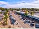 Street view of a quaint shopping area with palm trees and parked cars, highlighting local businesses at 14098 Baracoa Ln, Port Charlotte, FL 33981