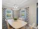 Bright dining room features a white table and chairs, and stylish curtains at 14098 Baracoa Ln, Port Charlotte, FL 33981