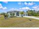 Single-story home with 2-car garage and palm trees at 14098 Baracoa Ln, Port Charlotte, FL 33981