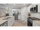 Modern kitchen boasts stainless steel appliances and granite countertops at 14098 Baracoa Ln, Port Charlotte, FL 33981