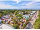 Overhead view of a bustling outdoor market by the water, surrounded by trees and community buildings at 14098 Baracoa Ln, Port Charlotte, FL 33981