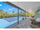 Covered patio with seating area and view of a pickleball court at 14098 Baracoa Ln, Port Charlotte, FL 33981