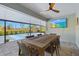 Covered patio with dining area and large TV overlooking a pickleball court at 14098 Baracoa Ln, Port Charlotte, FL 33981