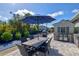 Outdoor patio with dining furniture and umbrella at 14098 Baracoa Ln, Port Charlotte, FL 33981