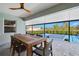 Covered patio with outdoor dining set and view of pickleball court at 14098 Baracoa Ln, Port Charlotte, FL 33981