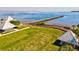 Beautiful waterfront view with a long pier and wooden boardwalk in a park-like setting at 14098 Baracoa Ln, Port Charlotte, FL 33981
