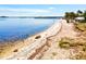 Sandy beach along calm, blue-green water at 14098 Baracoa Ln, Port Charlotte, FL 33981