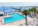 Inviting outdoor pool area with sparkling water, sun loungers, and scenic waterfront backdrop at 14098 Baracoa Ln, Port Charlotte, FL 33981